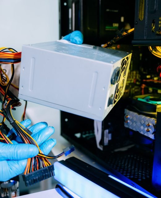 Computer technician in gloves safely repairing desktop hardware. Close-up view of hands fixing GPU and motherboard inside open PC case. Perfect for tech and repair concepts.