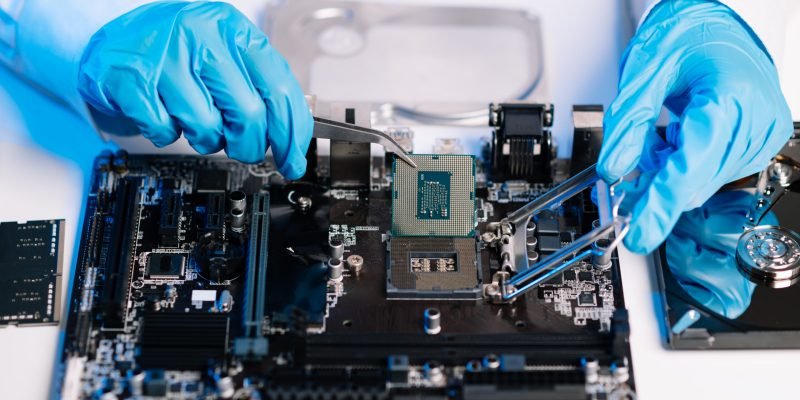 The technician repairing the motherboard in the lab with copy space. the concept of computer hardware, mobile phone, electronic, repairing, upgrade blue effect